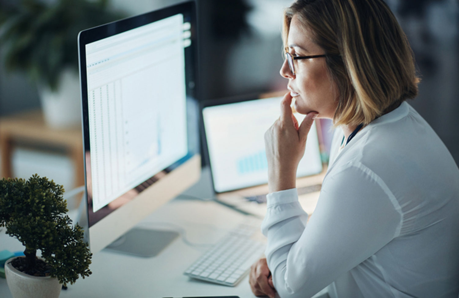 Women assessing data on a computer