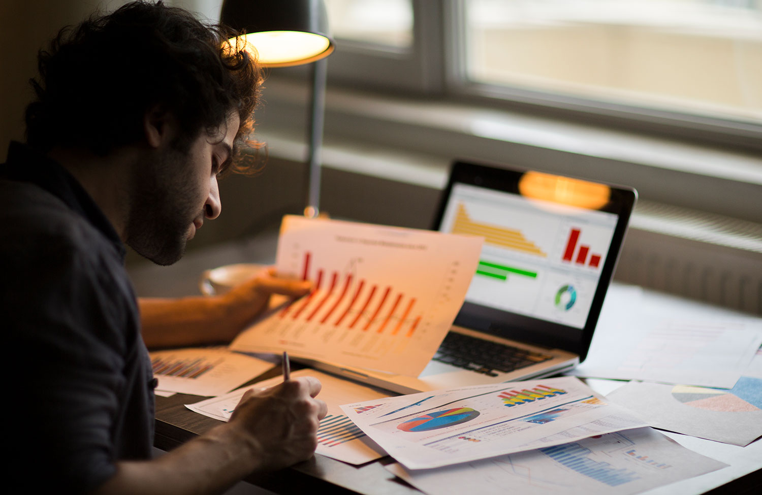 Man working on data materials at his desk