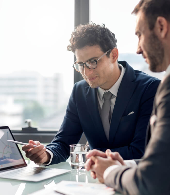 two men analyzing smart data solutions on laptop screen