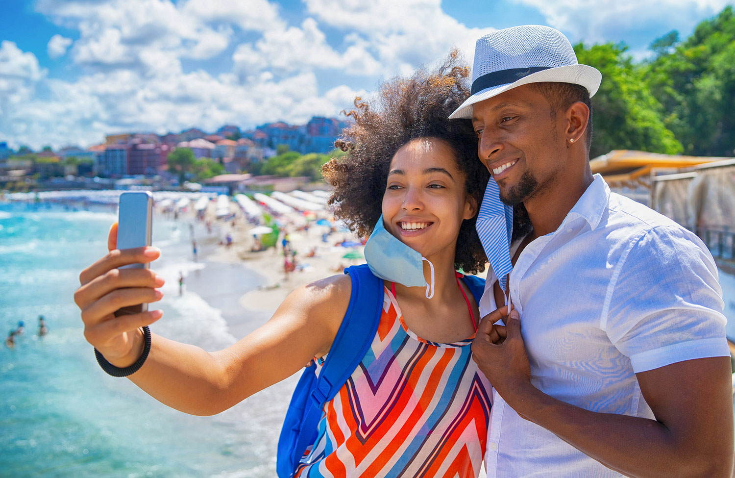 A smiling couple taking a selfie on vacation